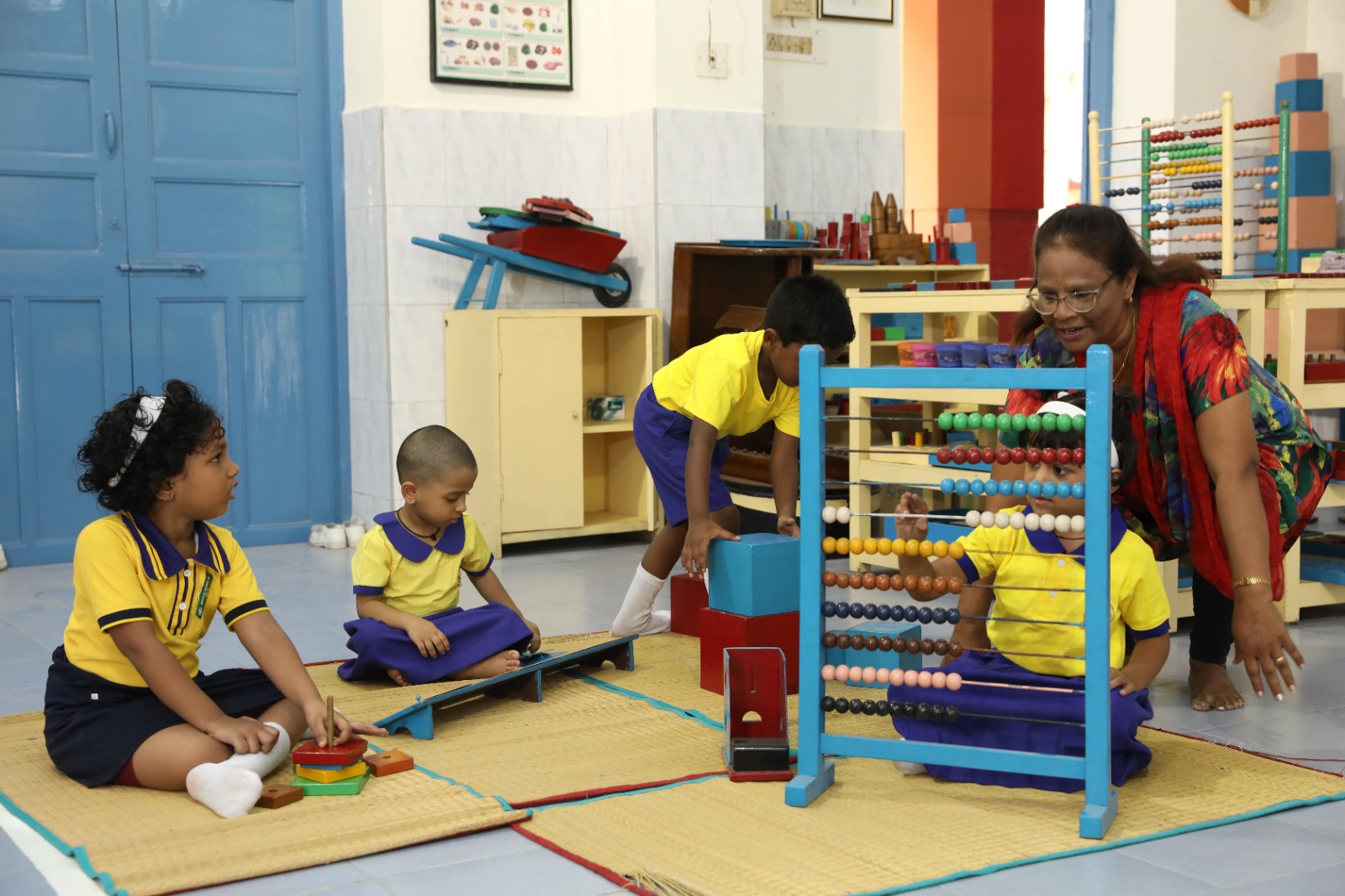 OLIS students in a hands-on Montessori learning activity