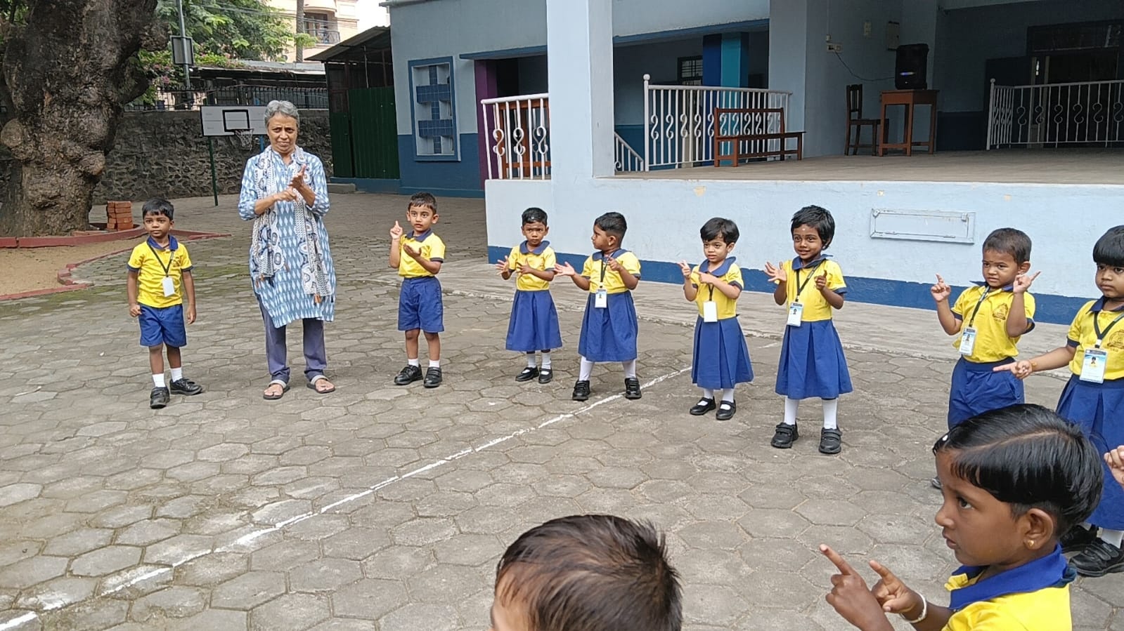 OLIS Time Playgroup children counting along with their teacher during outdoor circle time